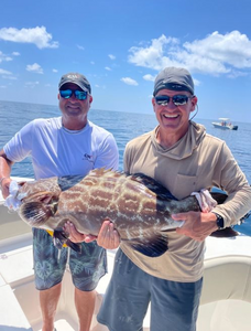Two anglers fishing in Florida with a large catch