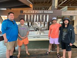 4 people fishing at Port Isabel