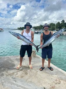 Two anglers with their catch of 2 big fish in Dominicus