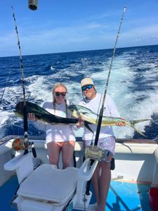 Two people fishing in Dominicus