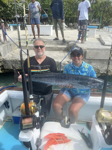 A group of 3 people fishing in Dominicus