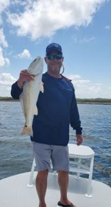 A person fishing with a rod in TX