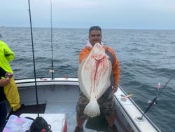 One fisherman holding a 26-inch fish in Hyannis