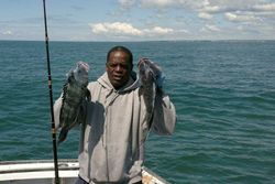 2 fishing rods with 2 fish caught in MA