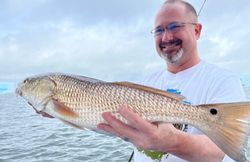 Angler catching a 25-inch redfish in St. Petersburg