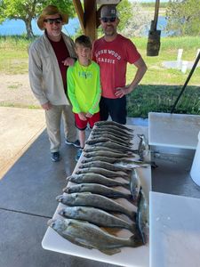 Three anglers with a big 23-inch fish in SD