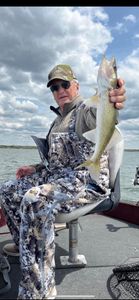 Single fisherman catching big fish in Pierre