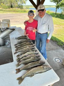 Two people fishing for two big fish in Pierre