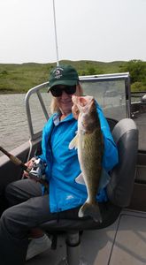 Angler with a trophy-sized walleye fish caught in Pierre