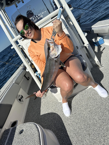 Fishing the clear waters of Pensacola, Florida, with a light tackle in the early morning rain.