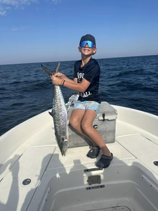 Photograph of a fisherman with a king mackerel fish measuring 23 inches, taken in Pensacola