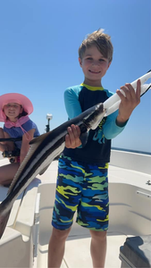A fisherman holds a large cobia fish caught in FL