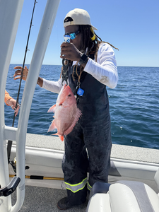 Hooked a feisty red snapper in Pensacola amidst the morning rain!