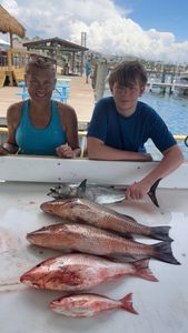 Two anglers with a catch of three fish on the coast of FL
