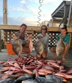 Two anglers with rods on Dauphin Island fishing cruises and fishing