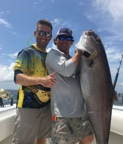 Two people enjoying a fishing cruise on the waters of Dauphin Island