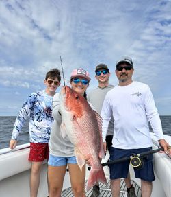 Four people enjoying a fishing cruise on Dauphin Island