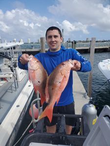 Two impressive mutton snapper fish caught during a fishing and hunting trip in Riviera Beach