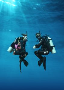 Two scuba divers underwater in blue ocean water near North Palm Beach FL