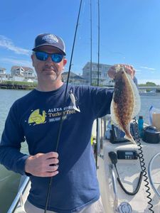 Angler holding a 12-inch fish in NJ