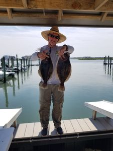 Two small fish caught by a person in Avalon