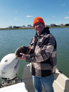 Angler holding a Southern Flounder fish in Avalon