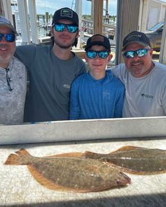 Two summer flounder, 22 inches long, caught while fishing in NJ