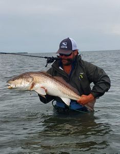Angler catching a redfish in MS