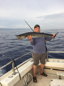 A fisherman with a large wahoo fish caught in Warrenton