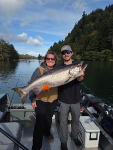 Two people fishing for a rainbow trout in Otis