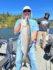 A photograph of two people fishing for a Chinook salmon in Washington state.