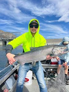 A fisherman holding a rainbow trout in Montesano