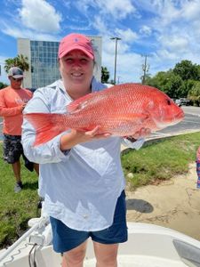 A photo of a yellow snapper, a 21-inch fish, caught by two people in Niceville