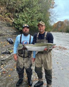 Two people fishing in Altmar, holding a 27-inch fish