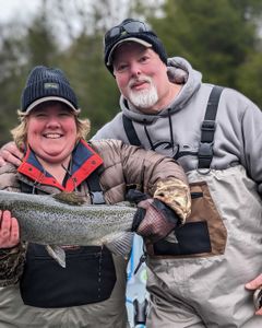 Angler reeling in a rainbow trout in Altmar