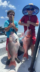 Two people fishing in Florida with 2 big fish