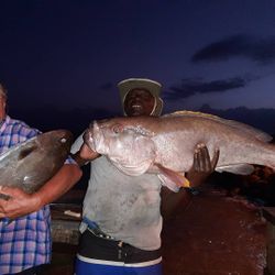 Two people fishing in Buccoo