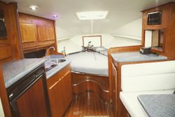 Interior cabin of a boat showing kitchen area with sink, countertops, seating area and berth in Tamarindo Guanacaste Province