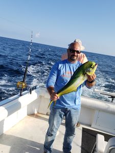 Fisherman posing with 13-inch catch in NJ