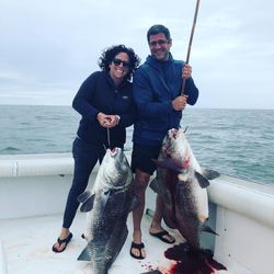 Two people fishing in the scenic Cape May location