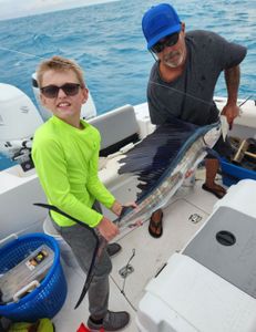 Two people fishing with a single fish in FL