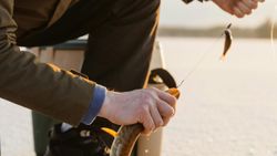 Hands gripping wooden walking stick during outdoor adventure in Florida City FL