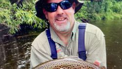 Angler holding spotted fish during fishing trip in Florida City FL