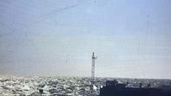 Fishing vessel on sparkling ocean water with tall mast in Florida City FL