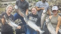 Successful fishing charter displaying caught Chinook and Coho salmon in Florida City FL