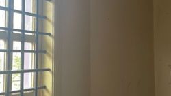 Empty indoor room with large gridded windows and natural lighting in Florida City FL