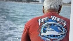 Tuna Wahoo fishing charter boat viewed from behind in Florida City FL waters