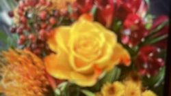 Yellow rose in floral arrangement with red flowers in Florida City FL