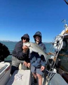 2 people fishing for a big fish in CA
