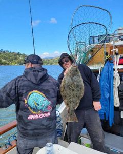 Photograph of a winter flounder, a 26-inch fish, caught while fishing in Richmond